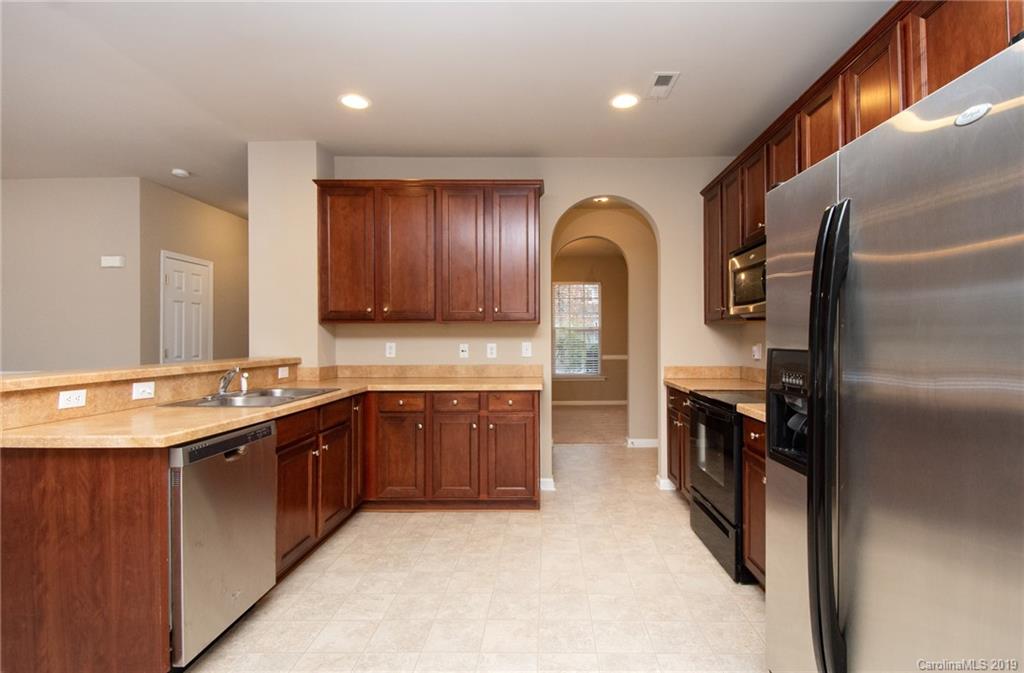 9824 Caldwell Depot Road Cornelius, NC 28031 - Photo 9 of 29 a large kitchen with stainless steel appliances granite countertop a sink and cabinets