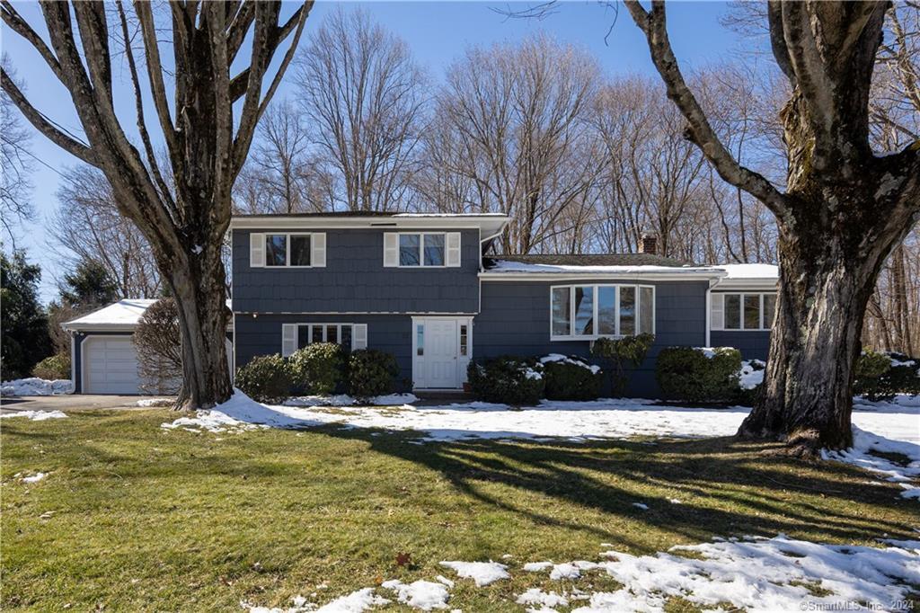a view of a house with a yard covered with snow in the porch