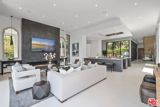 a kitchen with counter top space sink stove and microwave