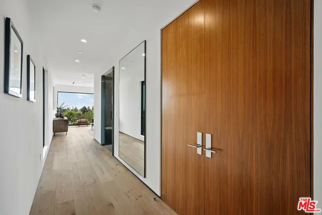 a living room with furniture large window and a flat screen tv