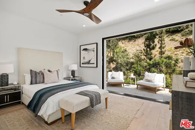 a bedroom with a bed and a mirror