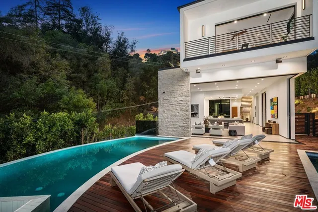 a view of a patio with couches table and chairs with potted plants