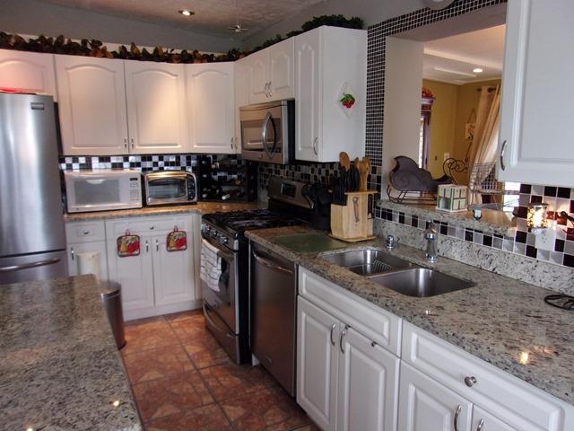 5588 South Rue Road West Palm Beach, FL 33415 - Photo 4 of 29 a kitchen with granite countertop a sink and a refrigerator