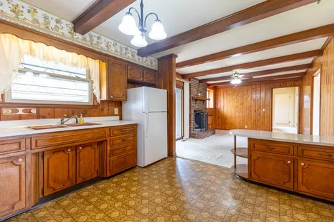 a spacious bathroom with a granite countertop sink and a bathtub