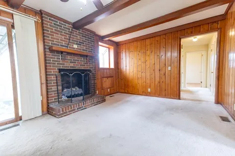 a view of empty room with fireplace