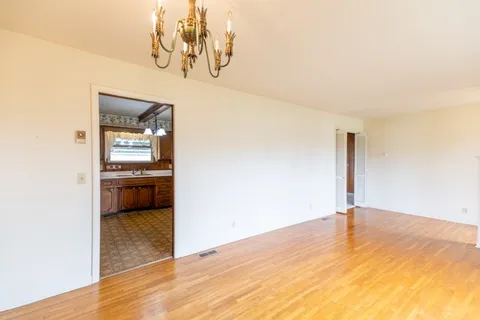 a view of a room with a sink and cabinet