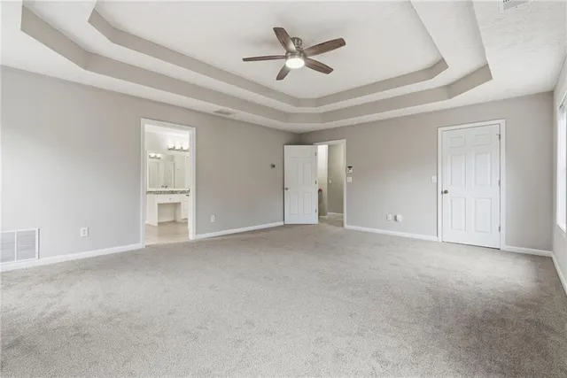an empty room with closet and windows