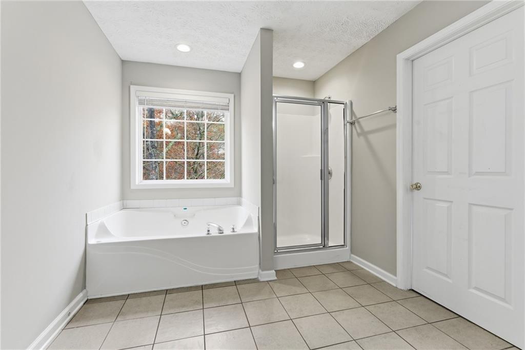 125 Nelson Oaks Drive Ball Ground, GA 30107 - Photo 26 of 41 a bathroom with a bathtub and a shower