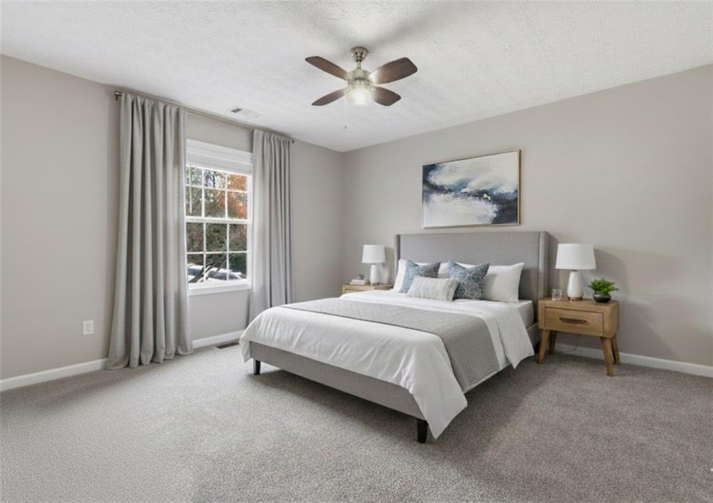 125 Nelson Oaks Drive Ball Ground, GA 30107 - Photo 30 of 41 a spacious bedroom with a bed and a window
