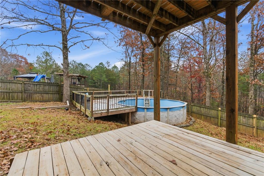 125 Nelson Oaks Drive Ball Ground, GA 30107 - Photo 35 of 41 a view of a balcony with wooden floor and fence