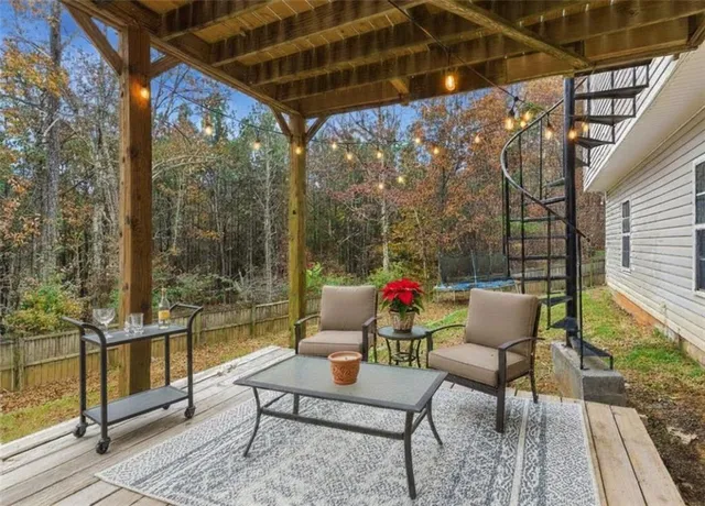 a view of backyard with a deck and wooden floor
