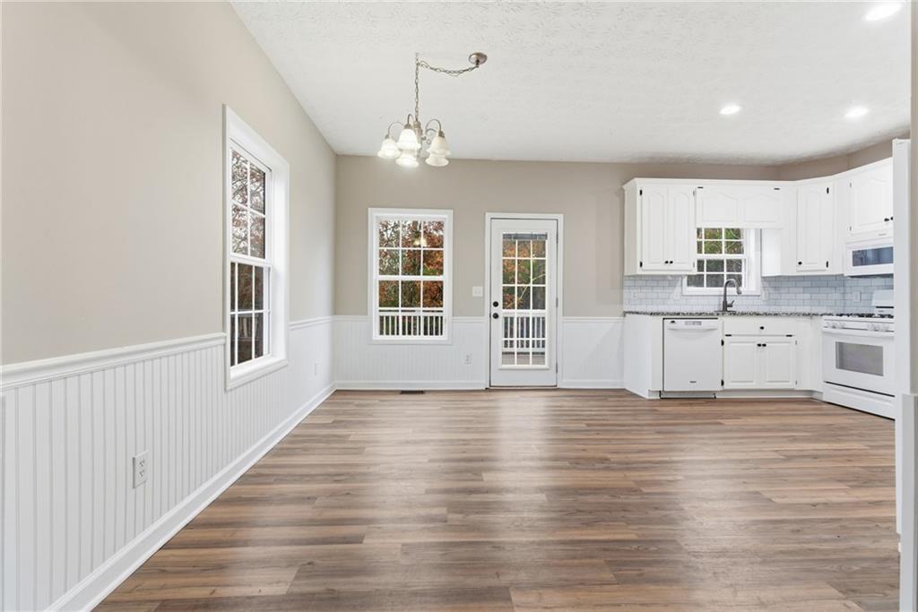 125 Nelson Oaks Drive Ball Ground, GA 30107 - Photo 9 of 41 a view of an empty room with window and wooden floor