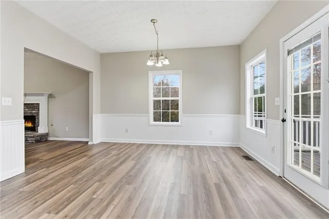 a view of wooden floor and a chandelier in a room