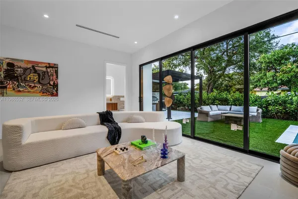 a living room with furniture and a garden