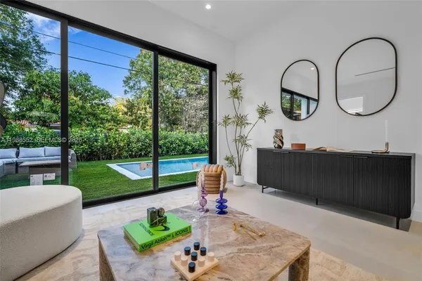 a living room with a large window and a table