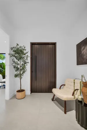 a view of a livingroom with furniture and a potted plant