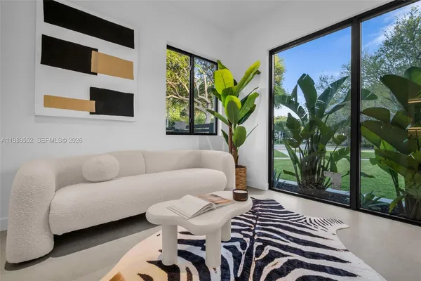 a living room with furniture and a large window