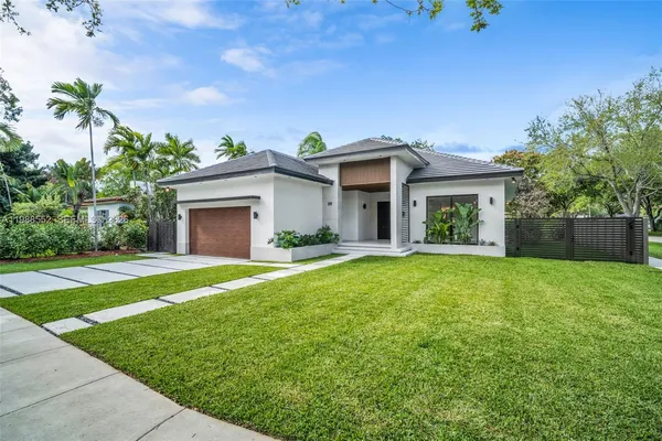 a front view of a house with garden