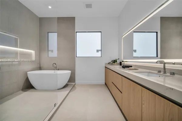a large spacious bathroom with a double vanity sink and a bathtub