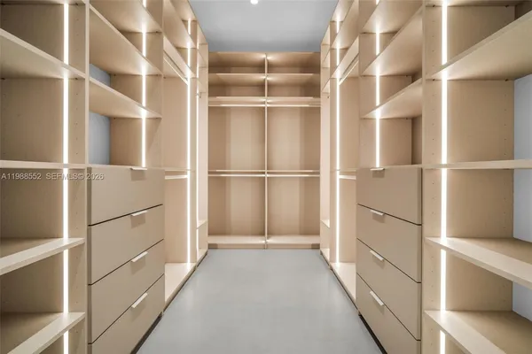 a view of walk in closet with empty racks