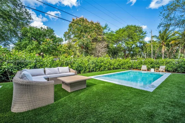 a view of yard with outdoor seating and green space