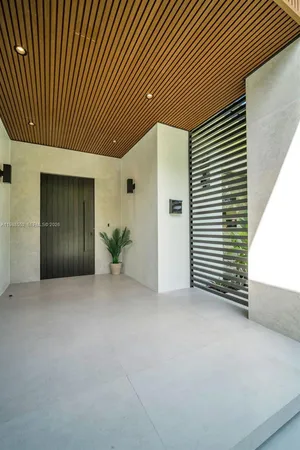 an empty room with windows and a wooden wall