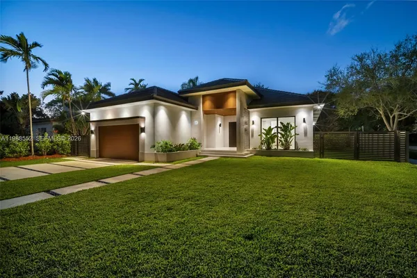 a view of an house with backyard space and patio