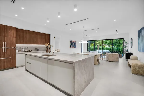 a kitchen with counter top space and living room