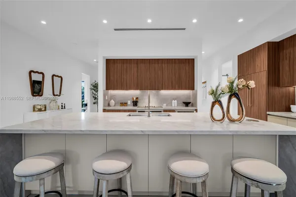 a kitchen with stainless steel appliances a sink a table and chairs
