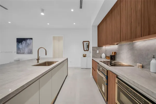a kitchen with sink a stove and cabinets