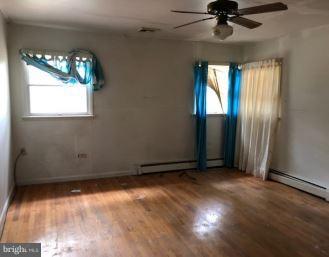 48595 Smith Drive Ridge, MD 20680 - Photo 5 of 8 an empty room with windows and fan