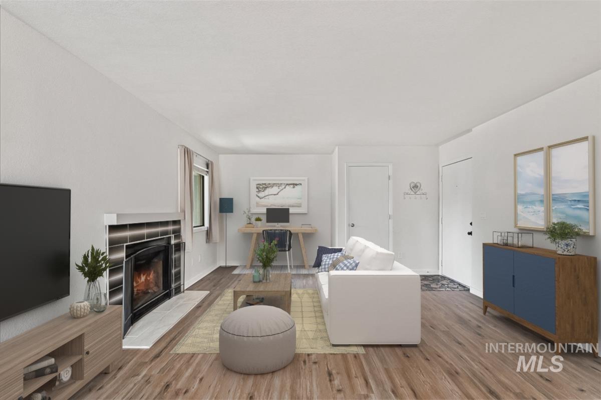 7084 West Colehaven Lane Boise, ID 83704 - Photo 6 of 23 Living area featuring light wood finished floors and a fireplace