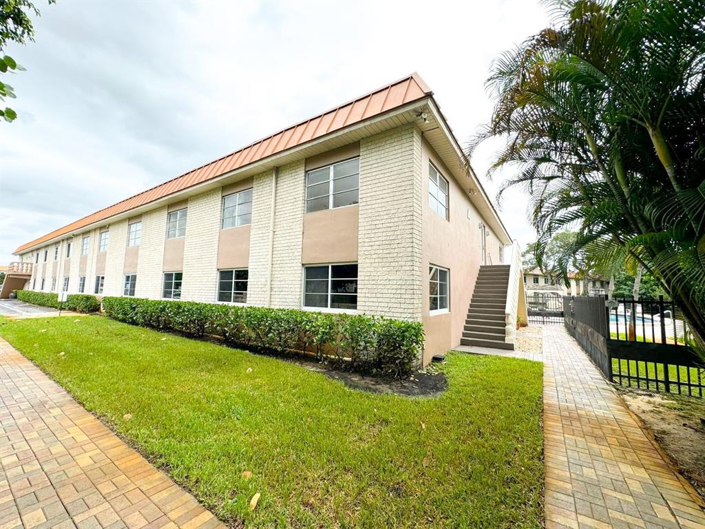 12 Northeast 19th Court, Unit 204A Wilton Manors, FL 33305 - Photo 15 of 21 a front view of a house with garden