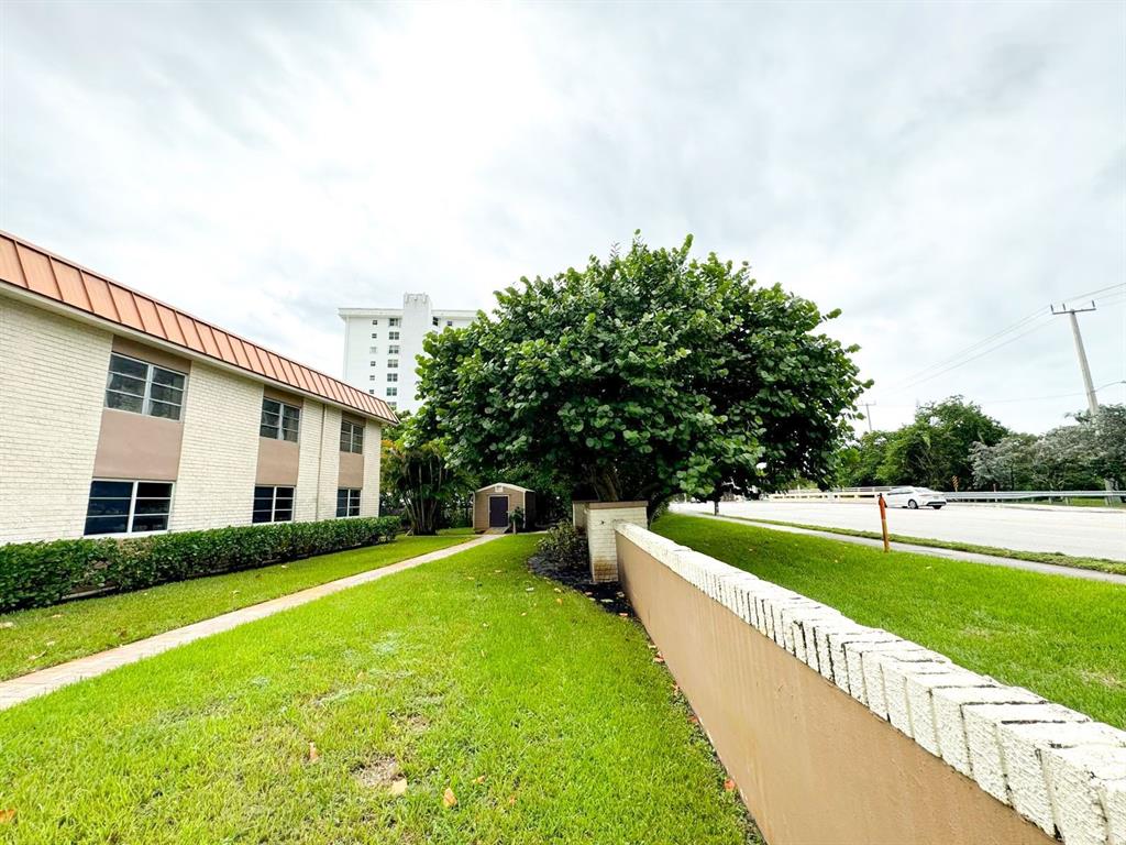 12 Northeast 19th Court, Unit 204A Wilton Manors, FL 33305 - Photo 16 of 21 a view of house with swimming pool and yard