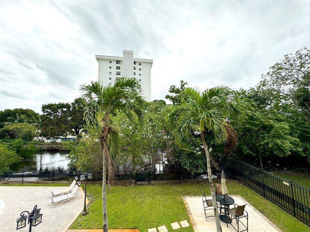 12 Northeast 19th Court, Unit 204A Wilton Manors, FL 33305 - Photo 19 of 21 a view of a swimming pool and lounge chairs