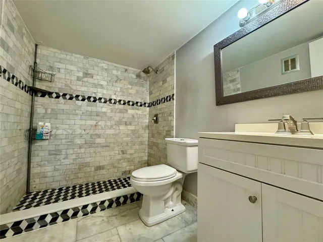 a bathroom with a toilet a sink and a shower