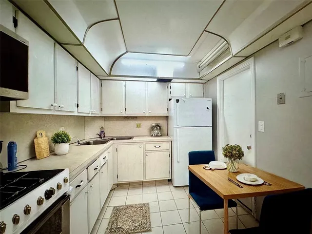 a kitchen with cabinets a sink and appliances