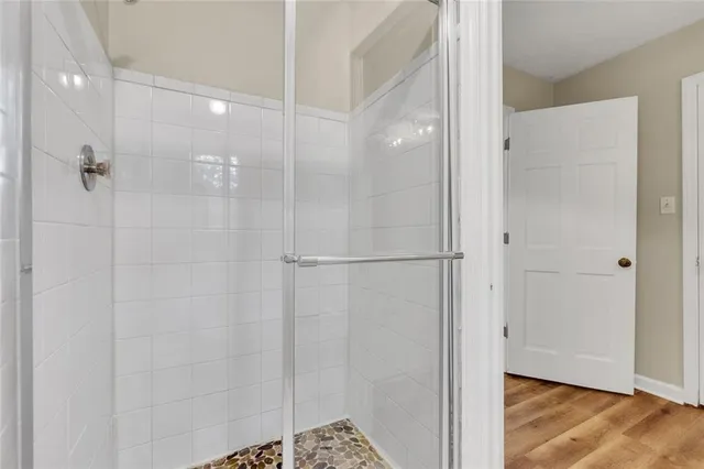 a bathroom with a granite countertop sink toilet a mirror and a window