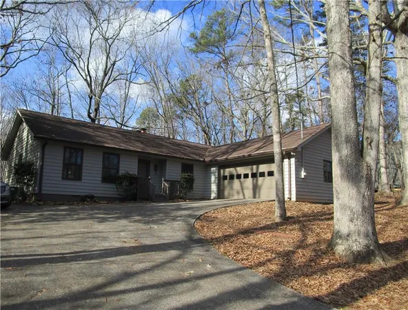 a view of a house with a large tree
