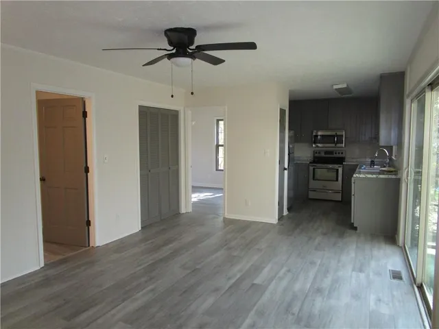 a view of a kitchen with a sink and stainless steel appliances