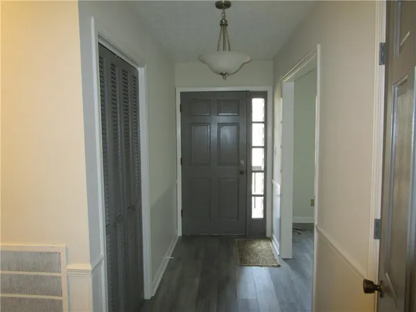 a view of hallway with wooden floor