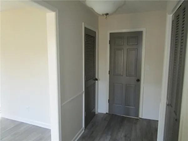 a view of a hallway with wooden floor