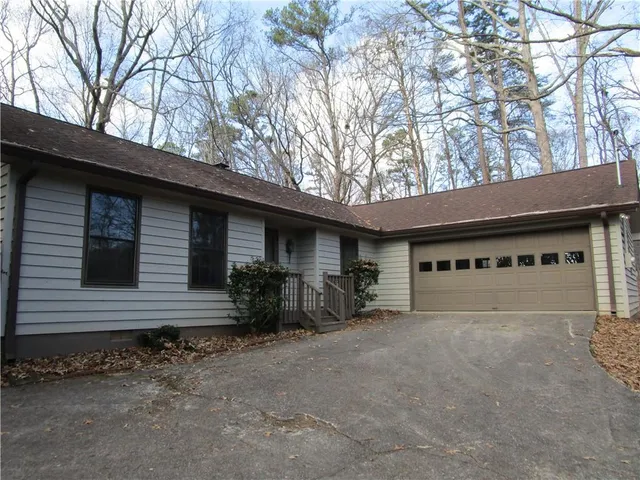 a view of a house with large trees