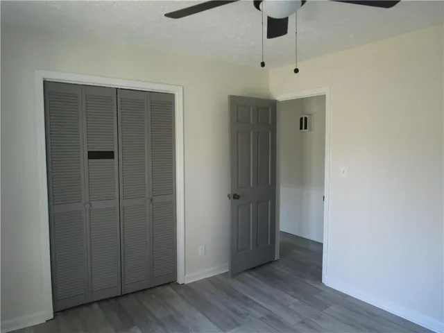 an empty room with windows and closet