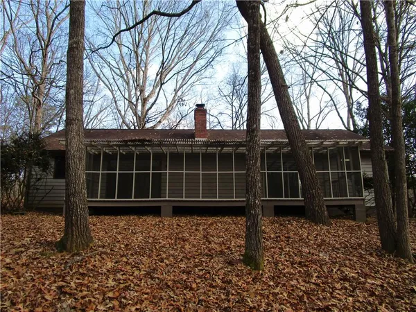 a view of a house with a large window and wooden fence