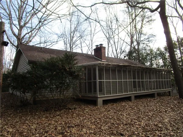 a view of a yard with wooden fence and a bench