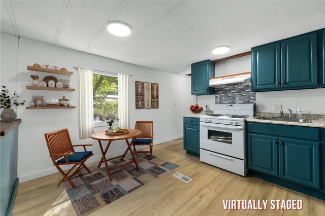 a kitchen with a stove a sink and a refrigerator