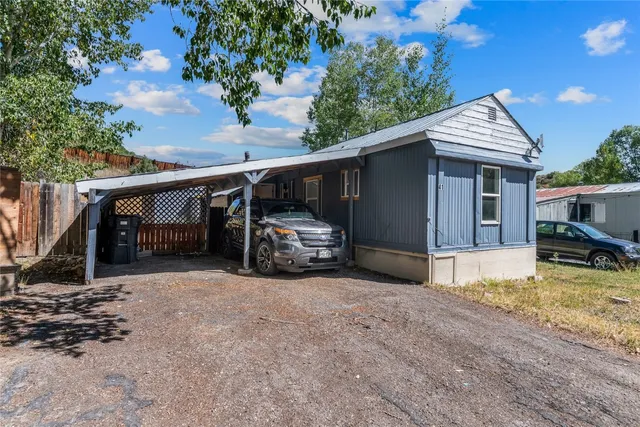 a view of a street with cars parked on the road
