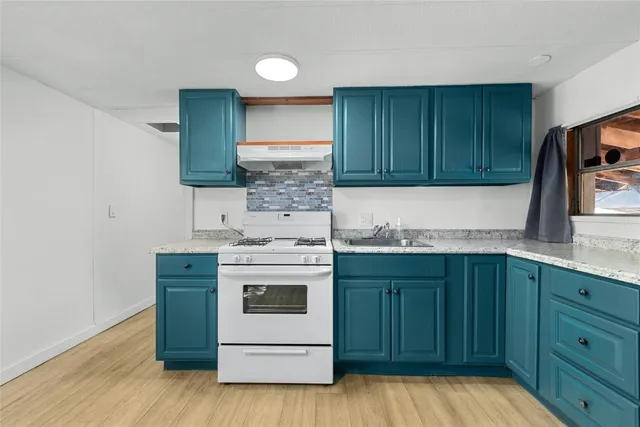 a kitchen with a stove and a sink