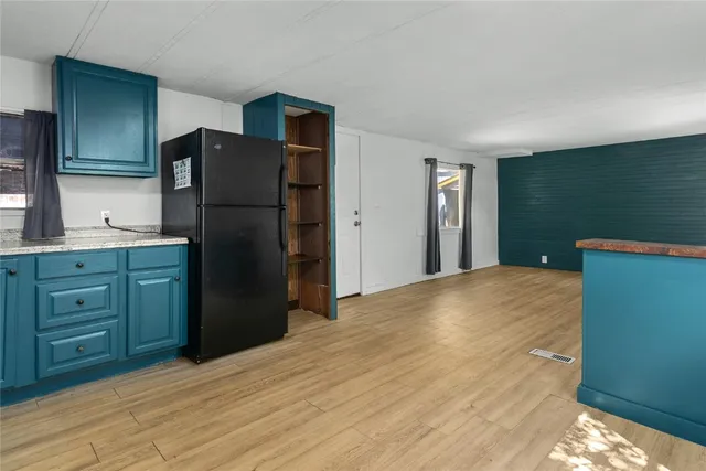 a kitchen with a refrigerator and a sink